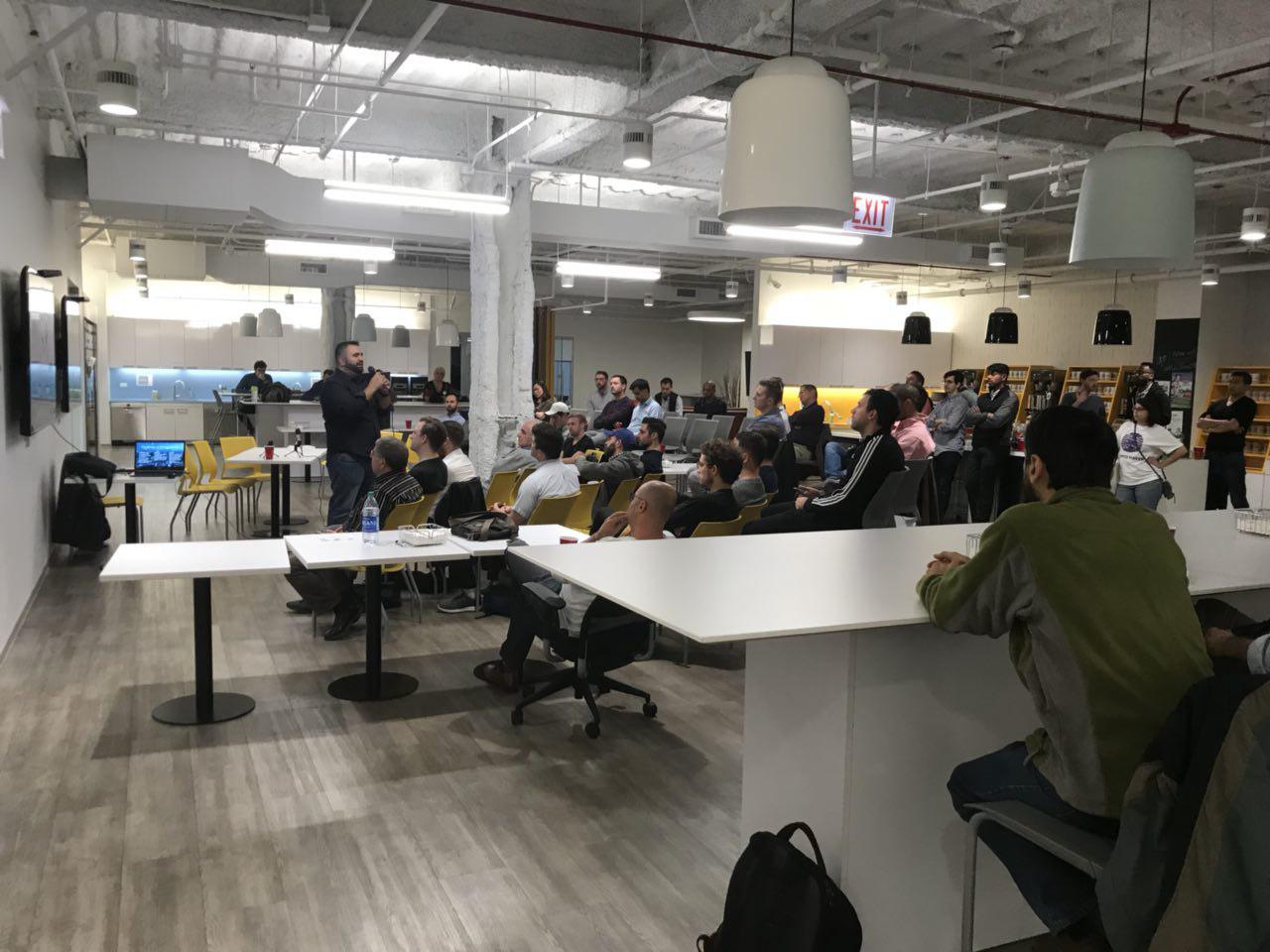 Joe Hernandez leading a session for a full room at a coworking space